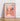 Almanac Co Prints framed poster of 'Aperol Spritz' with bright orange and blue colors, featuring a glass of spritz and bold typography