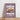 Framed purple Soho Espresso Martini poster by Almanac Co Prints on wood floor, featuring bold white text and cocktail illustration.